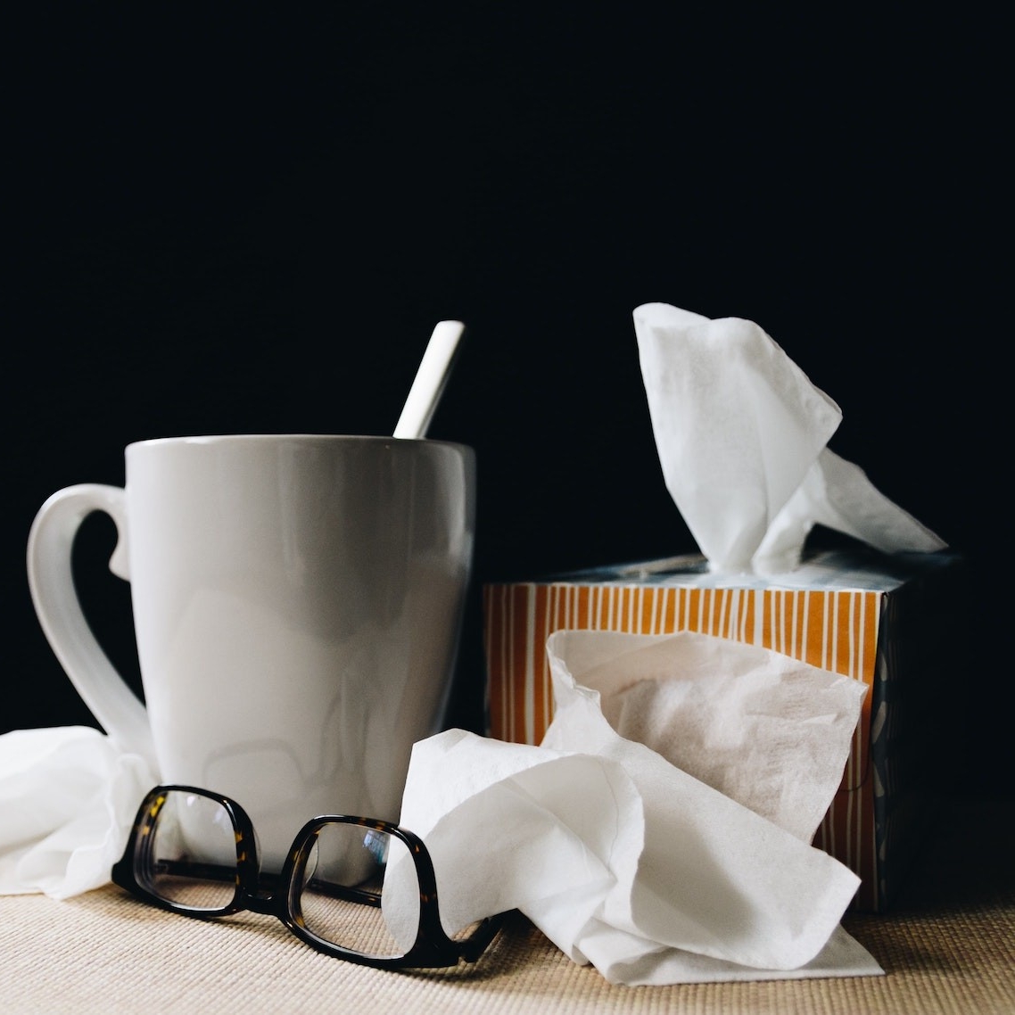 cold and flu tissue, glasses, and tea