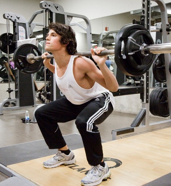 Male student lifting weights at the Concordia gym