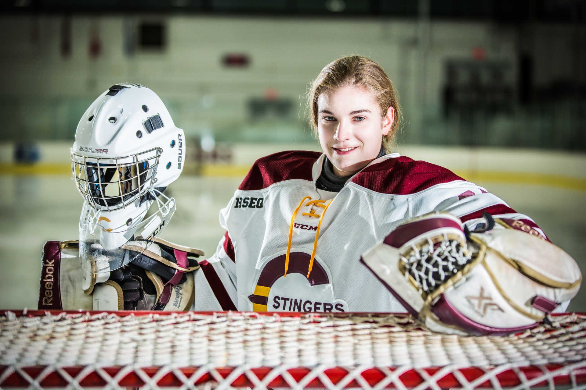 Stingers goalie Katherine Purchase leaning on hockey net