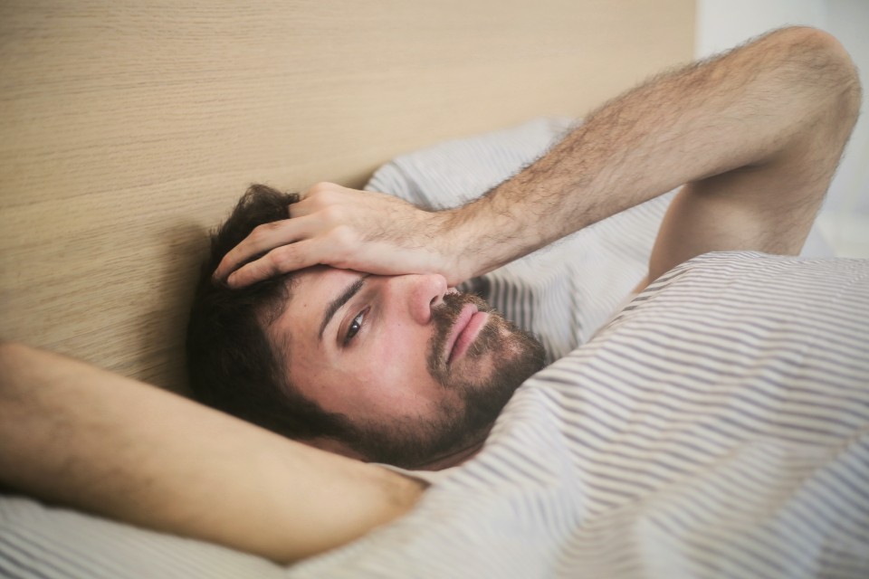 Man with insomnia laying in bed
