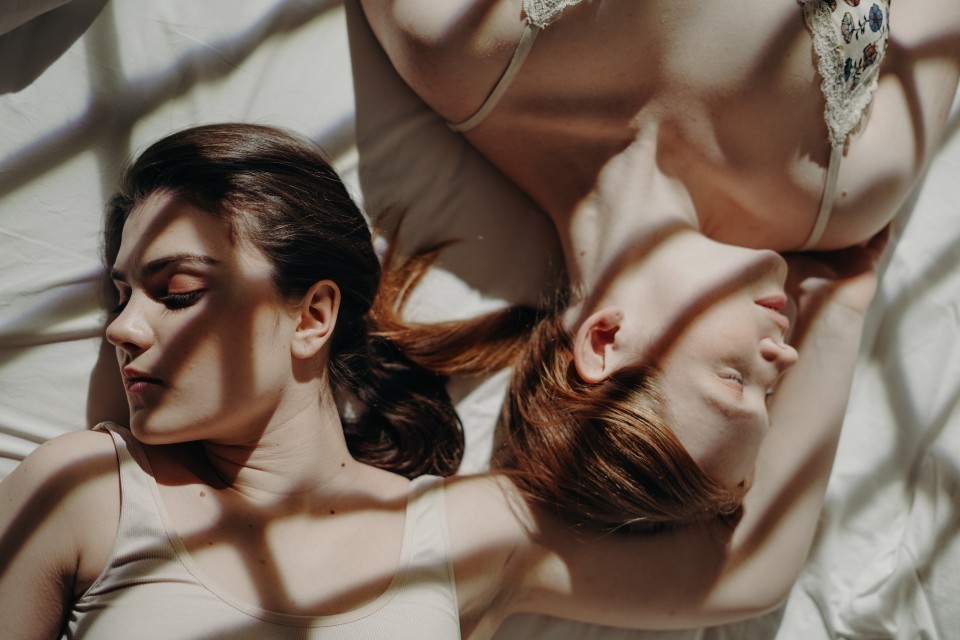Two women sleeping in bed
