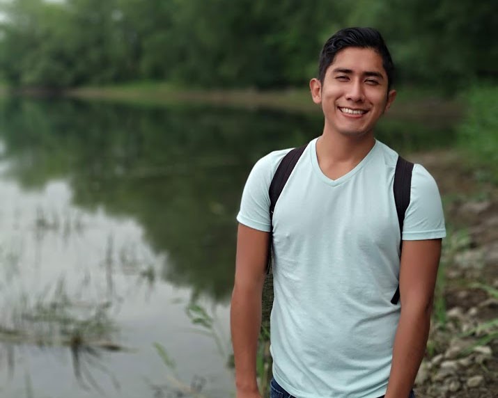 Omar standing by a lake