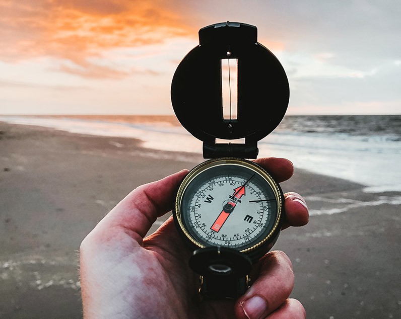 Compass pointing to seaside 