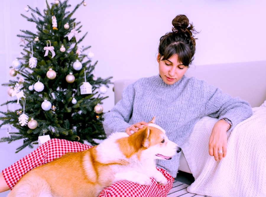 Woman resting with a dog during holiday season