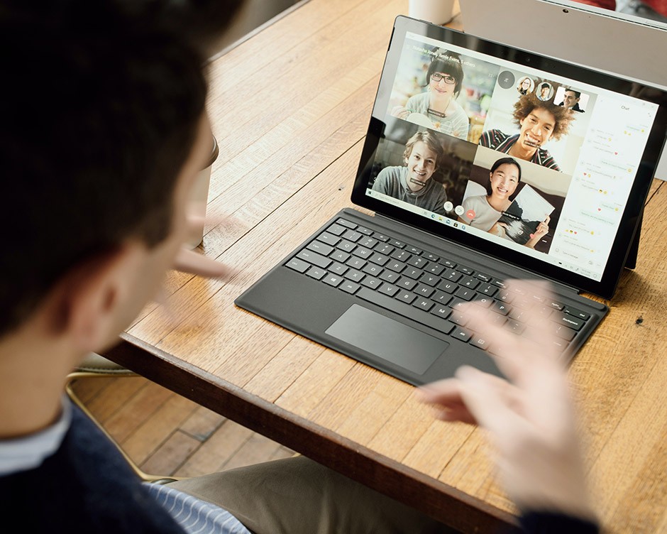 A man is engaging with others through online video conference platform