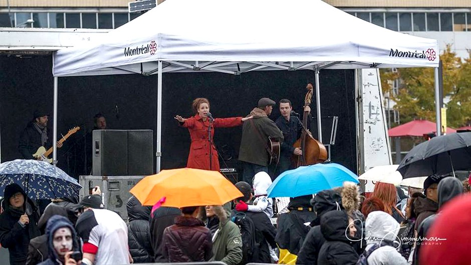 Band playing to zombies in the rain, red coat 