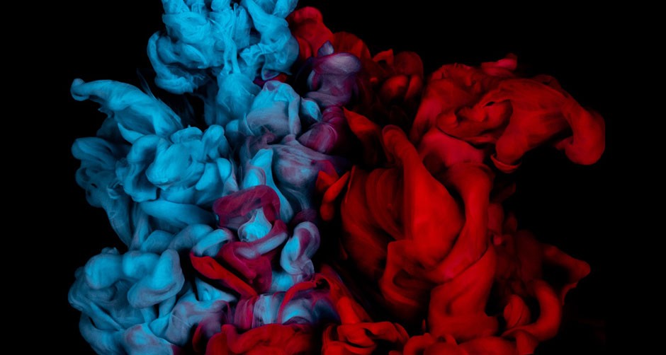 A splash of red and blue ink in water, getting blurred