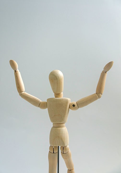 Wooden mannequin raised both arms up