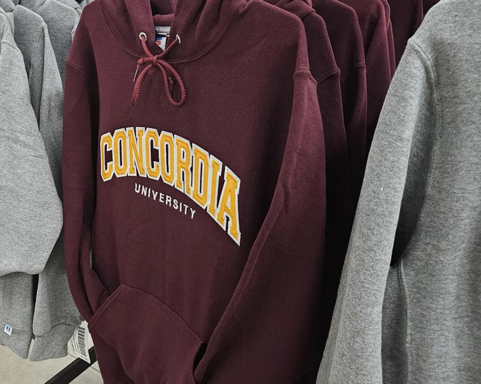 Concordia sweaters hung in the Concordia Book Stop boutique