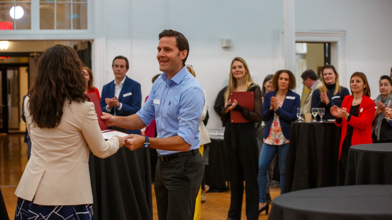 Joseph Leger, manager of research and graduate communications, receives his CRDP diploma from Natalie Camirand. 