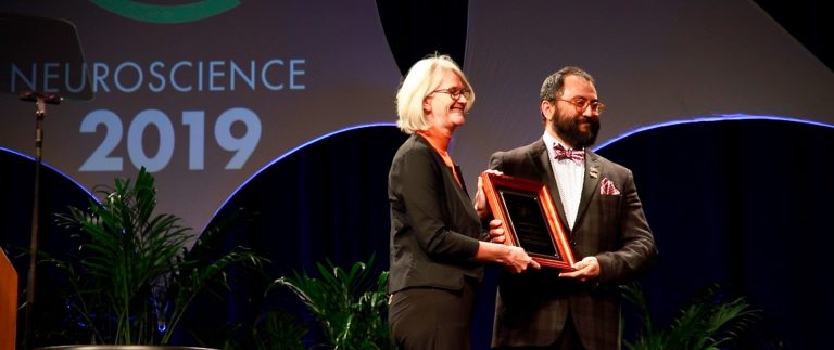 Cristian Zaelzer-Perez reçoit des mains de Diane Lipscombe, présidente de la Society for Neuroscience (2018-2019) le prix d’enseignement des sciences de l’organisme. | Photo : Cristian Zaelzer-Perez