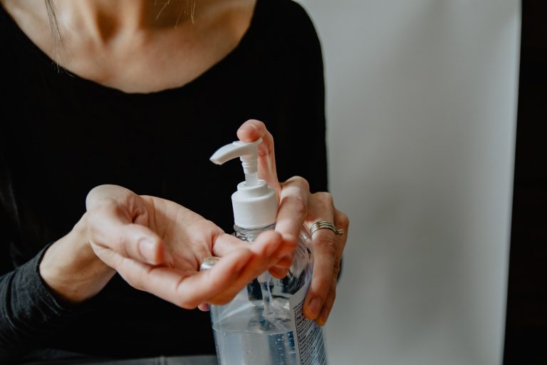 Woman using hand sanitizer