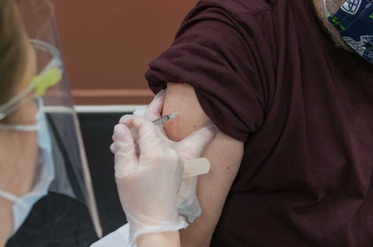 Patient receiving COVID-19 vaccination shot