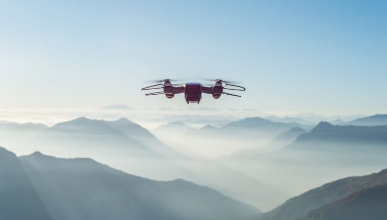 A drone flying over misty mountains