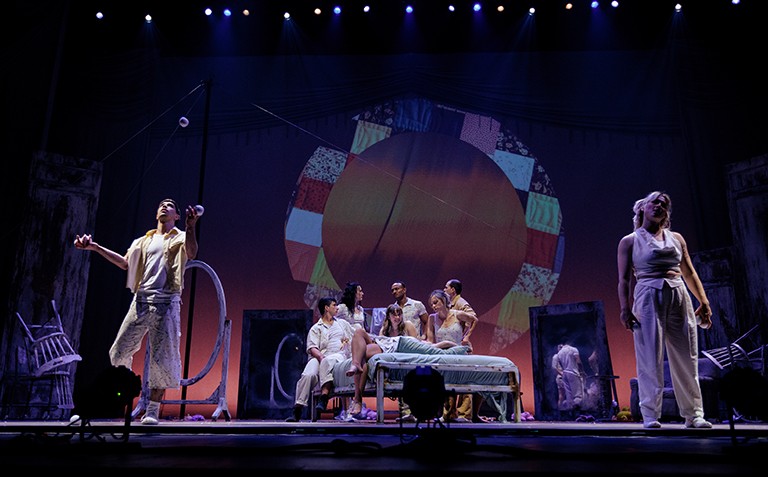 A group of young people on a stage rehearsing a theatrical play