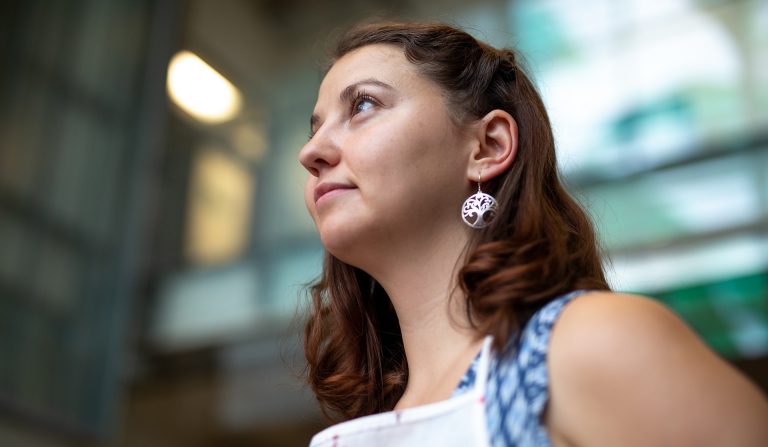 A women with brown hair, viewed from the side, looking up and off-camera to the left.