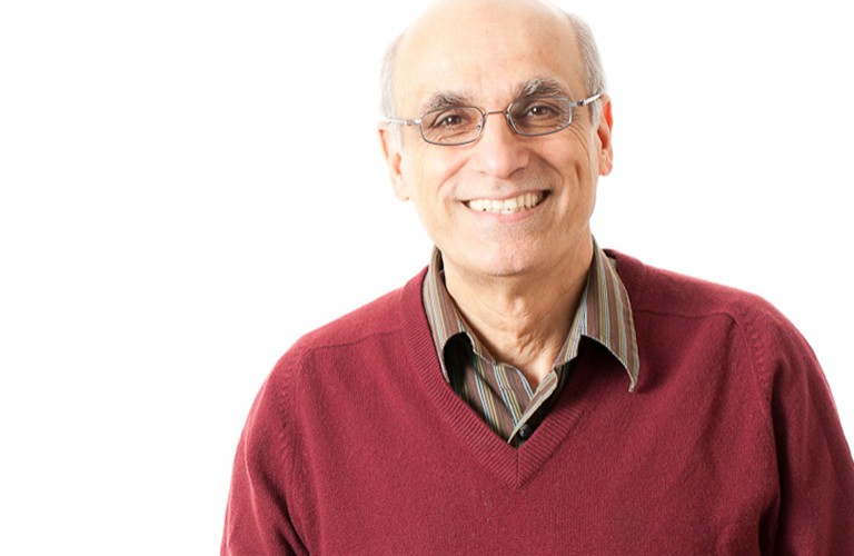 Hashem Akbari, professor of building, civil and environmental engineering. | Photo by David Ward An older, smiling man with spectacles and a red knit sweater.