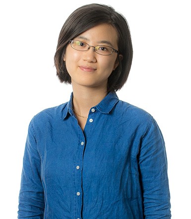 Young woman with straight black hair wearing glasses.
