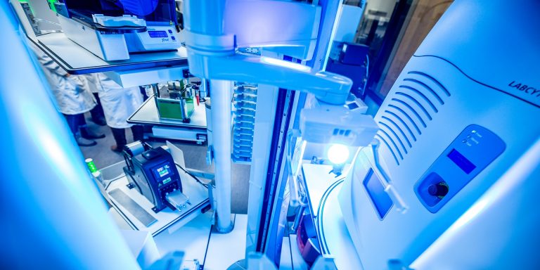 Overhead shot of white lab equipment with a blue glow.