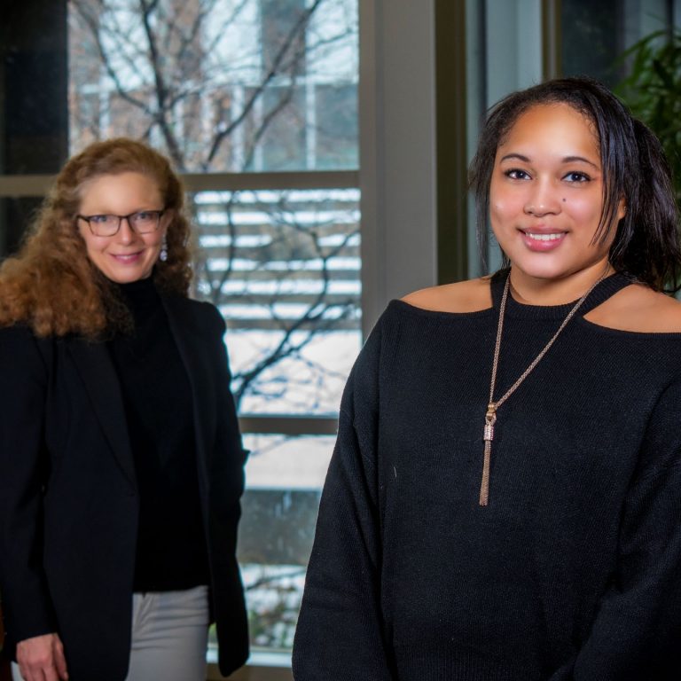 Two women standing in an office in winter