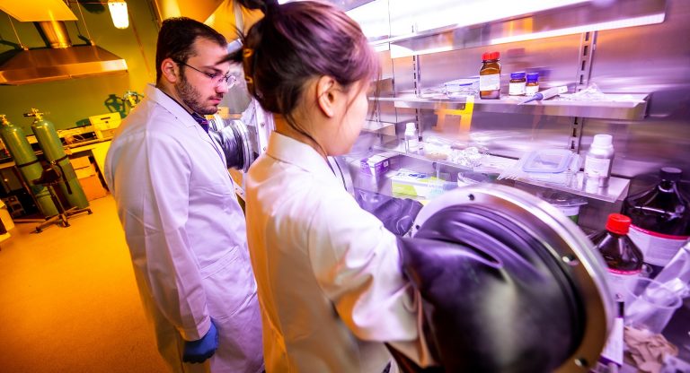 Two students in an engineering lab setting.