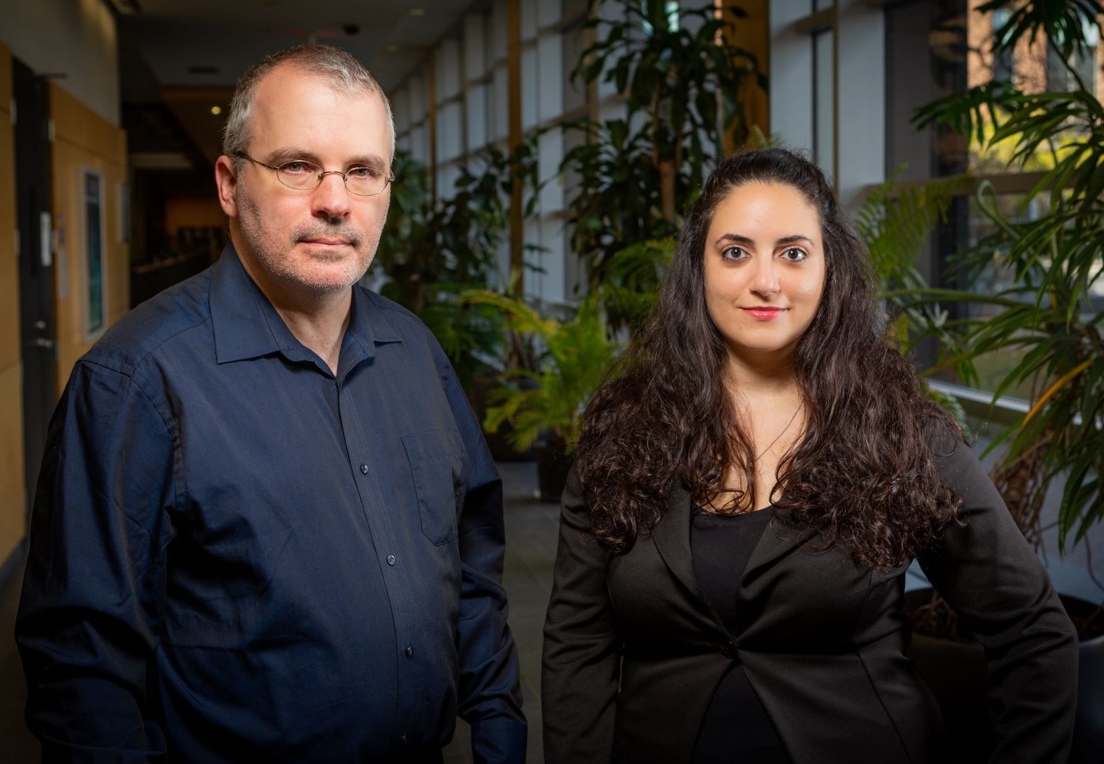 Andrew Ryder and Rebeca Bayeh standing in a hallway