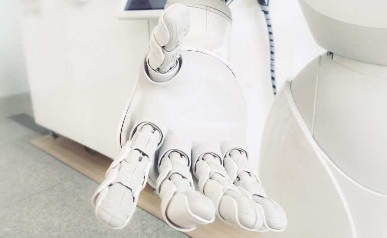 The open hand of a robot made of white plastic.