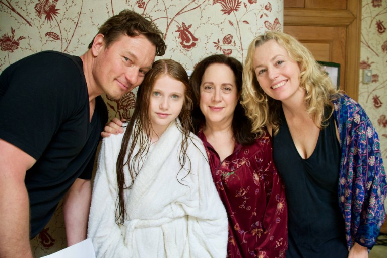 Mark Krupa, Chelsea Goldwater, Ellen David and Bonnie Harnden Group shot of man in black t-shirt, girl in white bathrobe, woman in burgundy patterned blouse and woman with black dress and open blue blouse