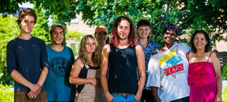 A group photo of diverse young people in an outdoor setting.