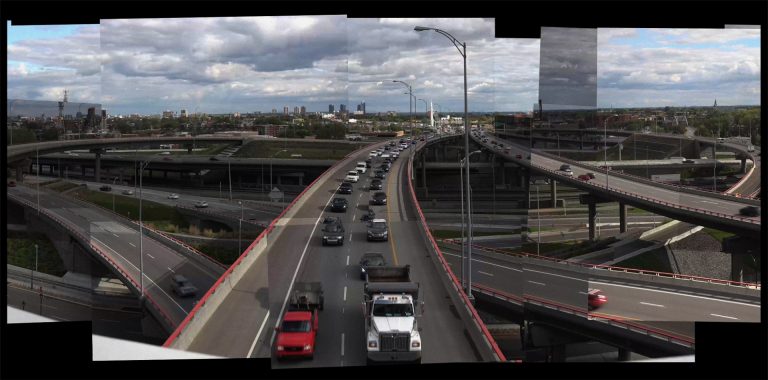Photograph of a digital video installation composed of roughly 700 video clips shot across eight hours from the same vantage point on Montreal’s Jacques Cartier Bridge.