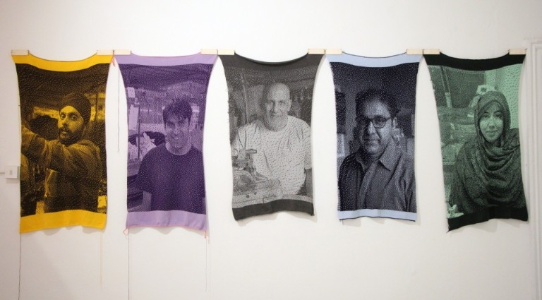 5 knitted portraits: one yellow, purplem grey, blue and green.