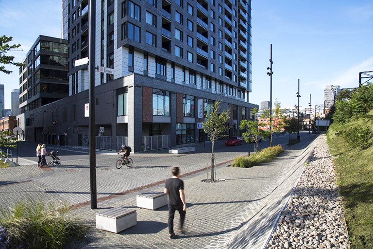 Smith Promenade, Griffintown. | Image courtesy of NIP Paysage Urban landscaping project with cobblestones and a grassy bank.