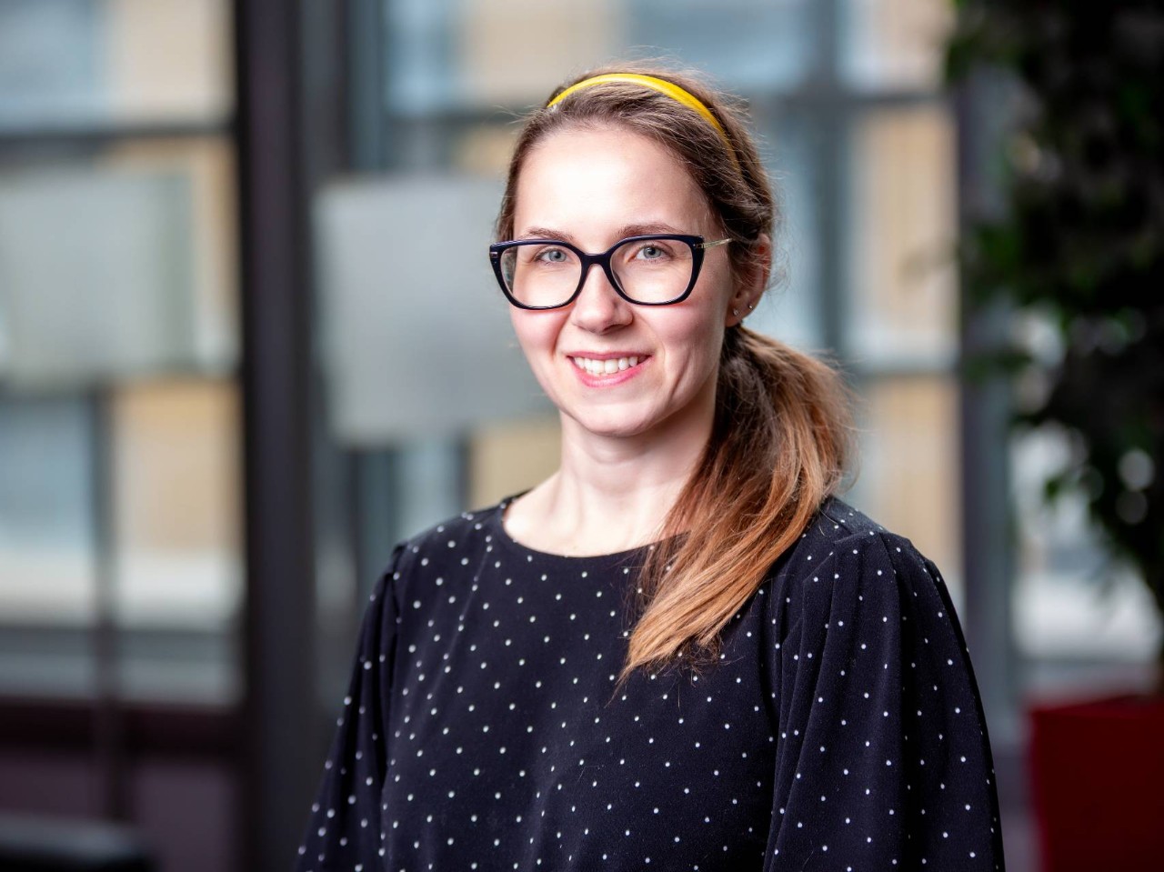 Portrait of Gail MacInnis, wearing glasses and dotted shirt