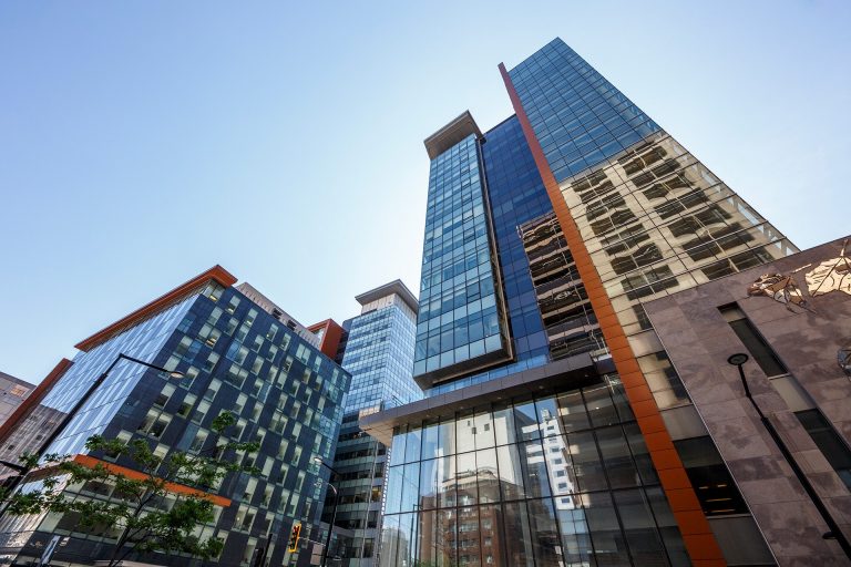 Modern skyscrapers against a beautiful blue sky.