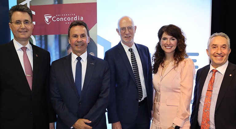 From left: Mourad Debbabi, dean of the Gina Cody School, Michel Angers, mayor of Shawinigan, Graham Carr, president of Concordia, Nancy Déziel, CNETE director and Karim Zaghib, professor. A group of four men and one woman standing should to shoulder and smiling for the camera.