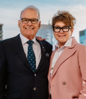 A smiling man and woman standing side by side