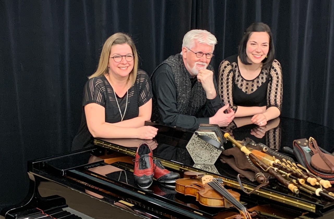 Trílangue ensemble: Martine Billette, Gearóid Ó hAllmhuráin and Kate Bevan-Baker at a piano with traditional Irish instruments