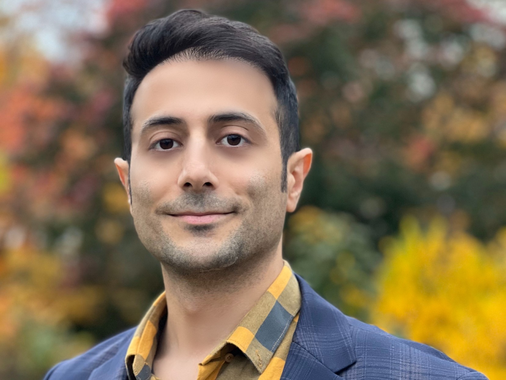 Navid Shirzadi Navid Shirzadi wears a blue jacket and yellow and blue shirt