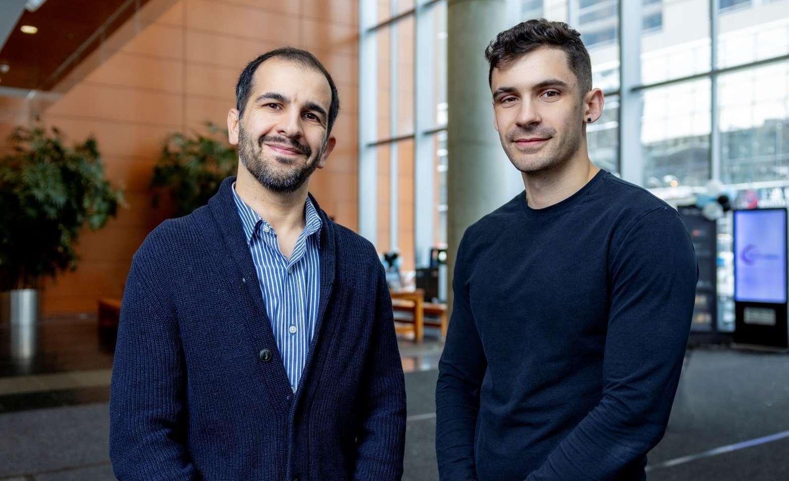 Mohsen Farhadloo (left) and James Peters stand in the lobby of Concordia's John Molson School of Business