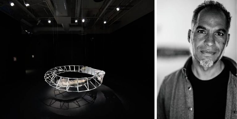 A diptych image with a ring structure/sculpture in a gallery on the left and a black and white portrait of a man with short dark hair, a goatee beard and wearing a black t-shirt and open collared shirt