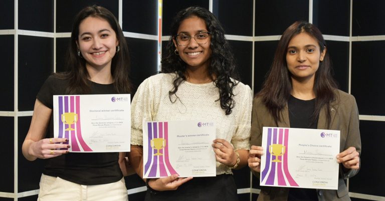 Three smiling young women, holding up their certificates for winning the Three Minute Thesis competition.