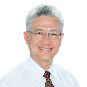 Smiling man with short, silver hair, wearing a white shirt