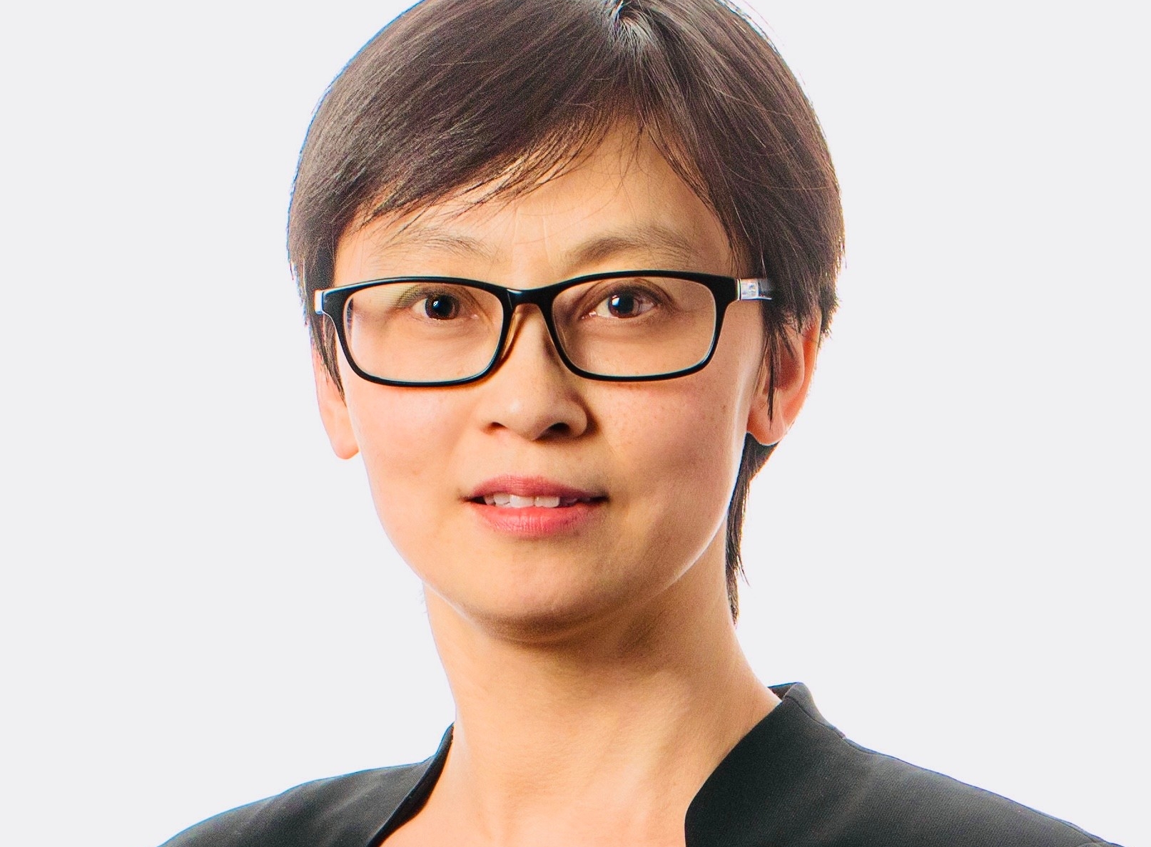Xiaodan Pan has her hair cut short and wears glasses and dark jacket and shirt. 