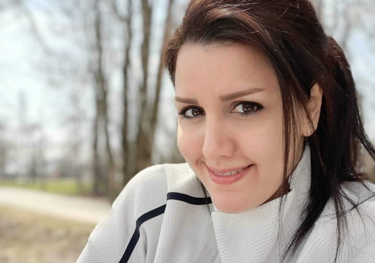 Maryam Sharifi Rad wears a white sweater and smiles