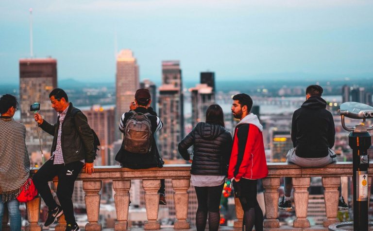 A group of people look out from the Mont-Royal Belvedere