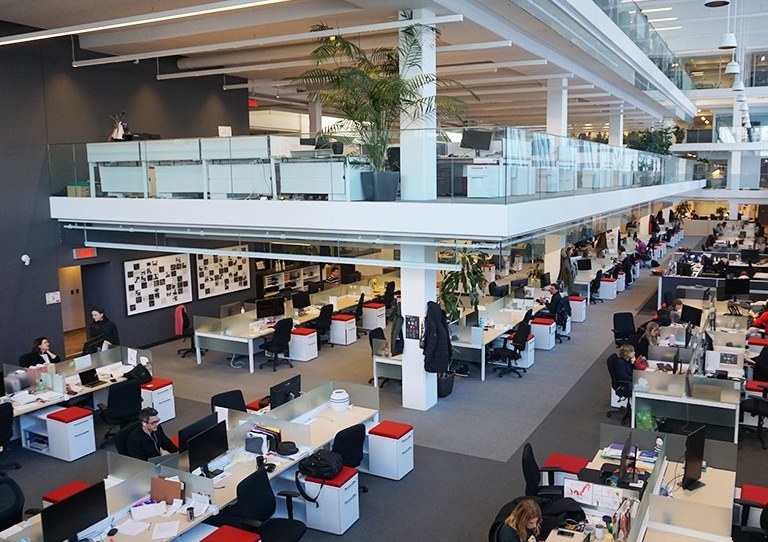 Photos by Leo Litke A large, bright open space with people working at desks