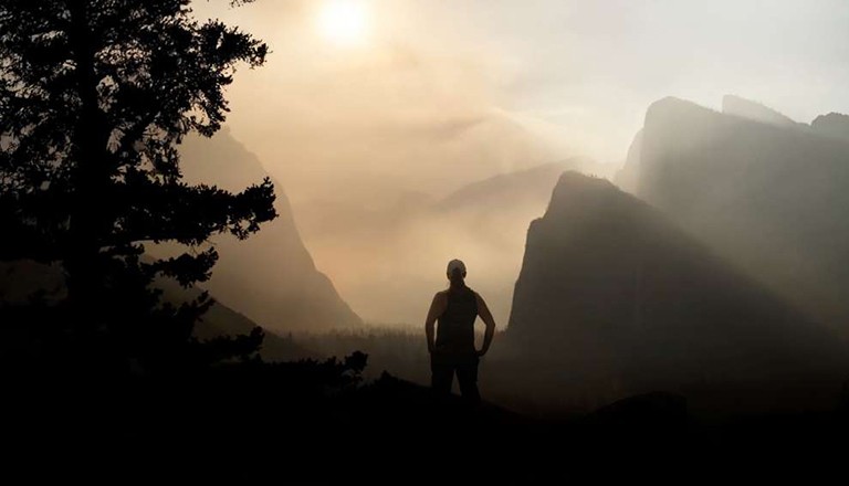 Au Pied Du Mur is about defying every kind of limit, in a quest to grow old gracefully and audaciously. Silhouette of a person in a mountainous area at sunset