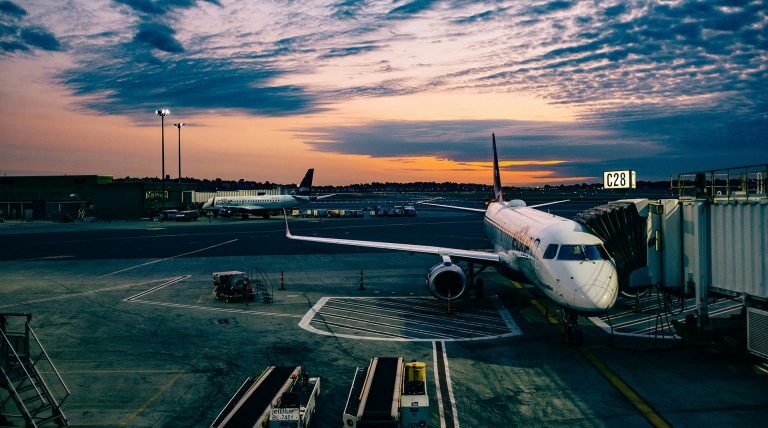 A plane on the tarmac at sunset