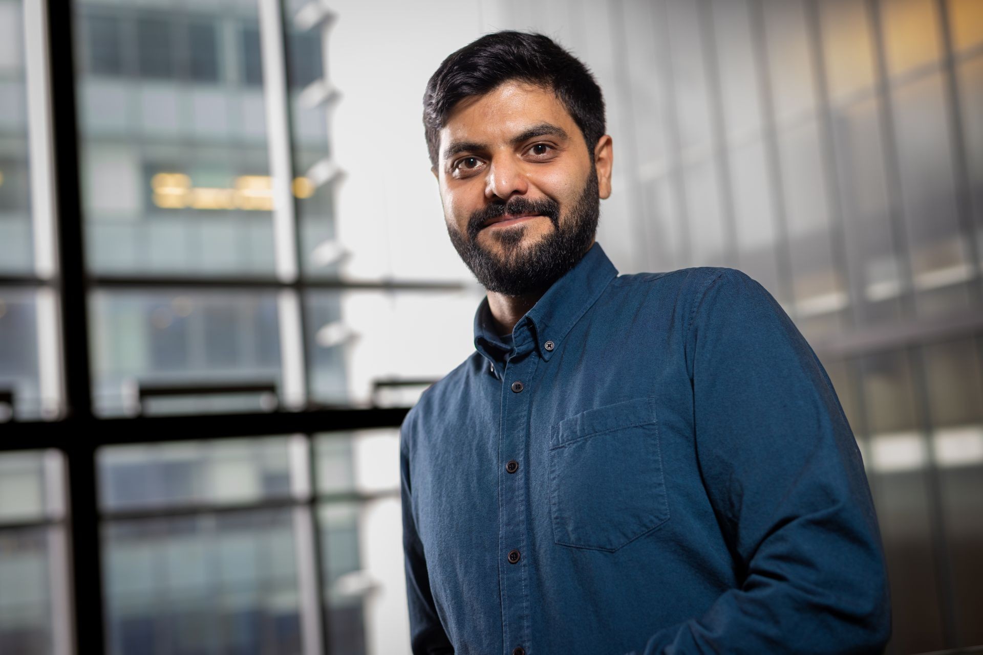 A man with a beard in a blue shirt