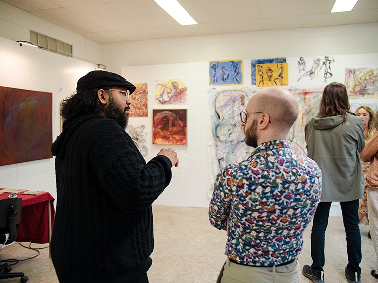 People in discussion at an art exhibition